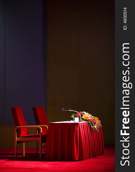 Podium isolated on black background with microphone and red table. Podium isolated on black background with microphone and red table