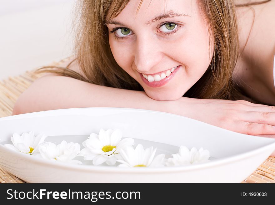 Close up of fresh and beautiful young woman laying on bamboo mat / taking spa treatment / aromatherapy. Close up of fresh and beautiful young woman laying on bamboo mat / taking spa treatment / aromatherapy