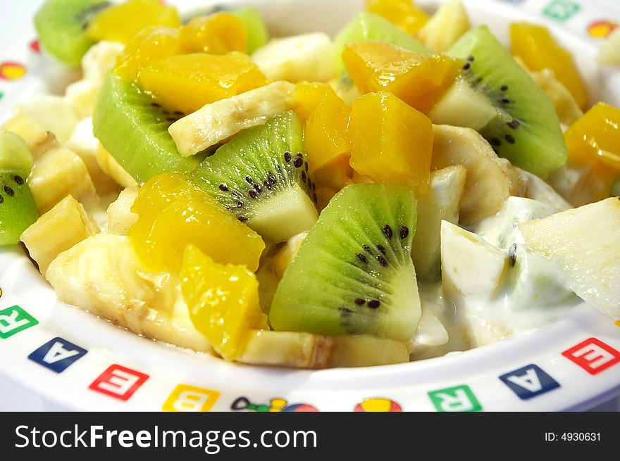 Fruit salad from kiwi, a banana, an apple and a mango