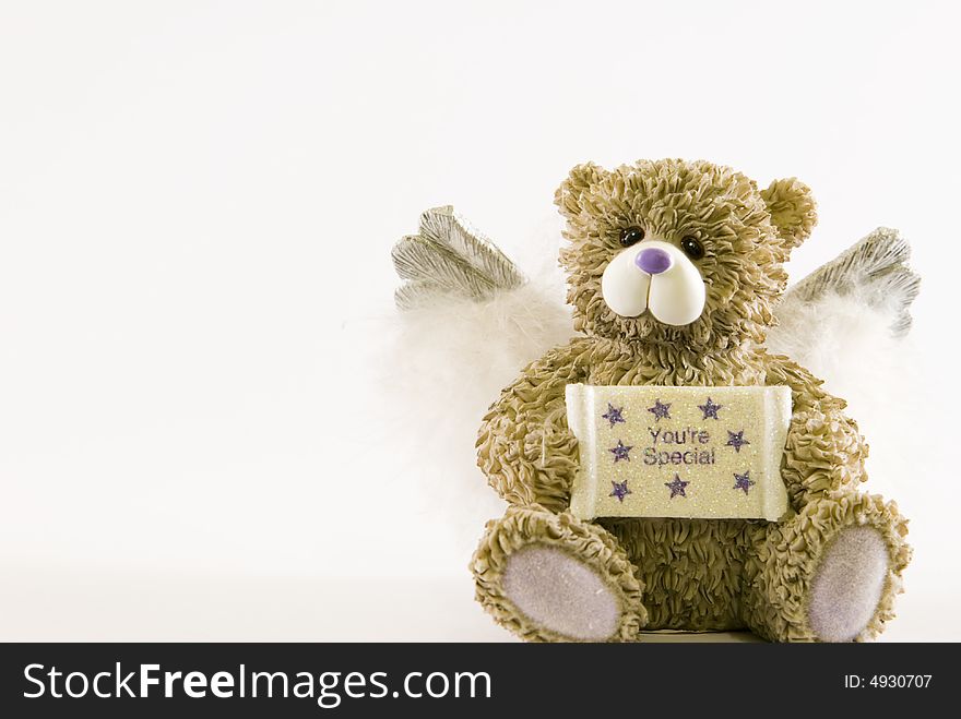 Nice and little teddy bear over white background