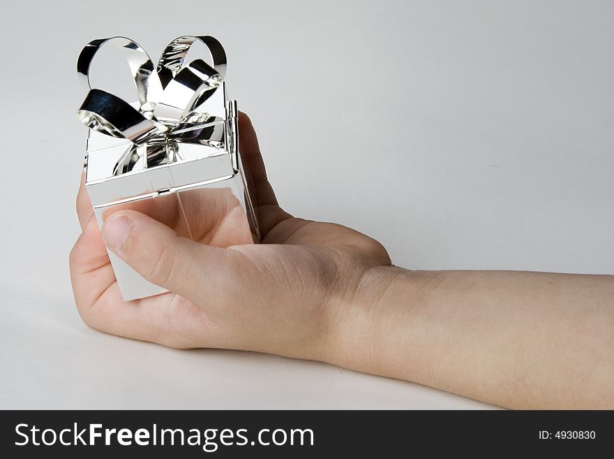 Silver jewlery box holded by a child´s  hand. Silver jewlery box holded by a child´s  hand