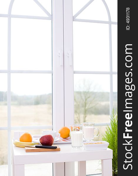 Table with healthy snacks / fruits, joghurt, cereal. Table with healthy snacks / fruits, joghurt, cereal