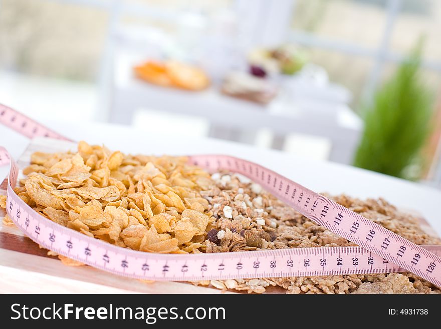 Cereal on the board and measure tape. Cereal on the board and measure tape