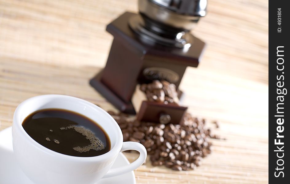 Black coffee, grinder and coffee beans