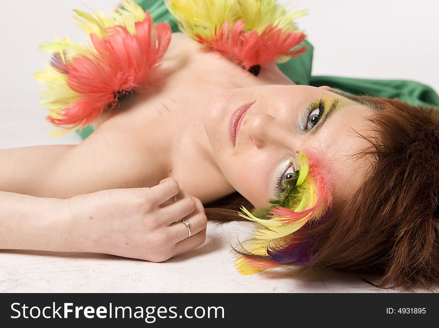 Fashion model with feather on face
