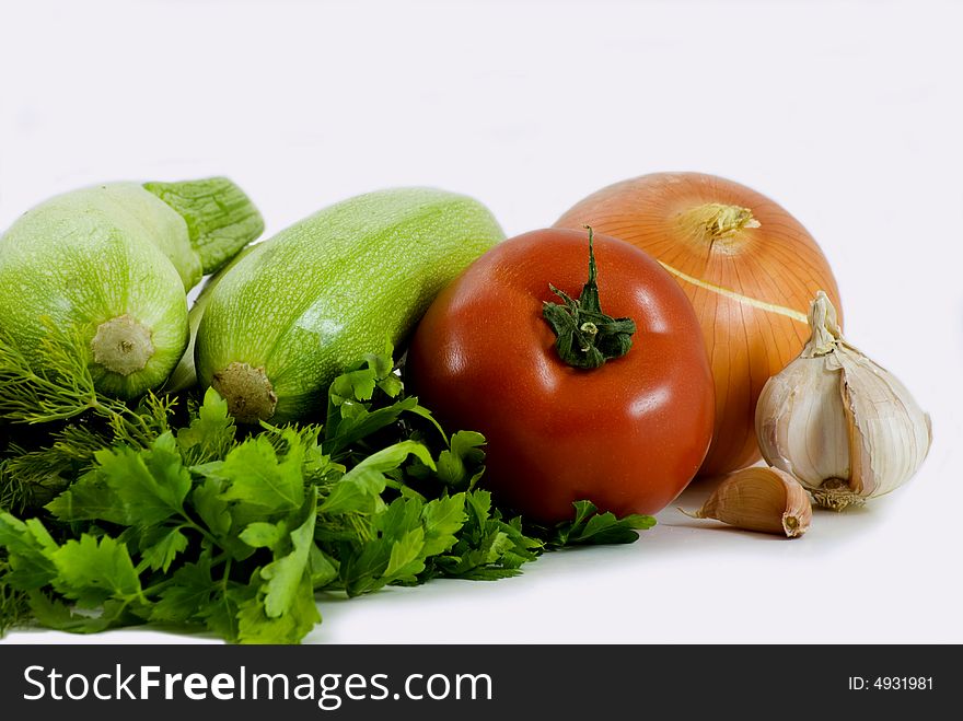 Zucchinis and tomato isolated on white background. Zucchinis and tomato isolated on white background
