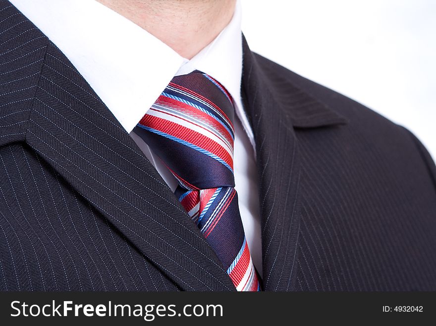 Black fashion costume, cravat with red and blue stripes, and white shirt. Black fashion costume, cravat with red and blue stripes, and white shirt