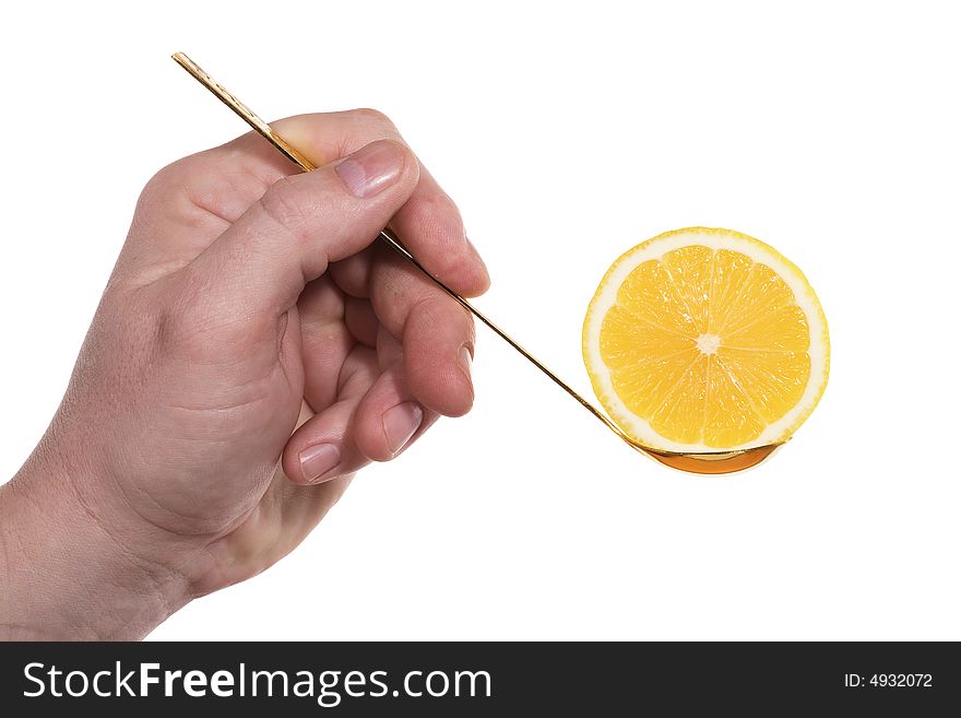 The hand holds a teaspoon with lemon. Isolated on white [with clipping path]. The hand holds a teaspoon with lemon. Isolated on white [with clipping path].