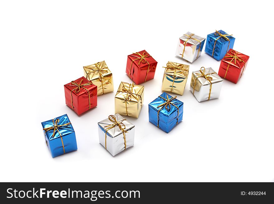 Brilliant multi-coloured gift packings on a white background with reflection. Brilliant multi-coloured gift packings on a white background with reflection