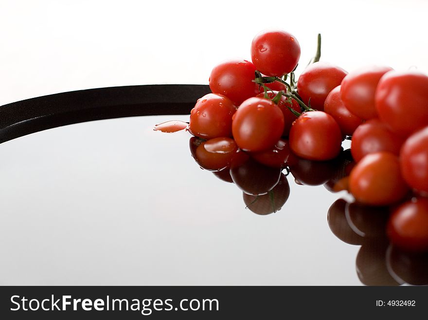 Tomato-cherry in the bowl full of fresh water. Tomato-cherry in the bowl full of fresh water