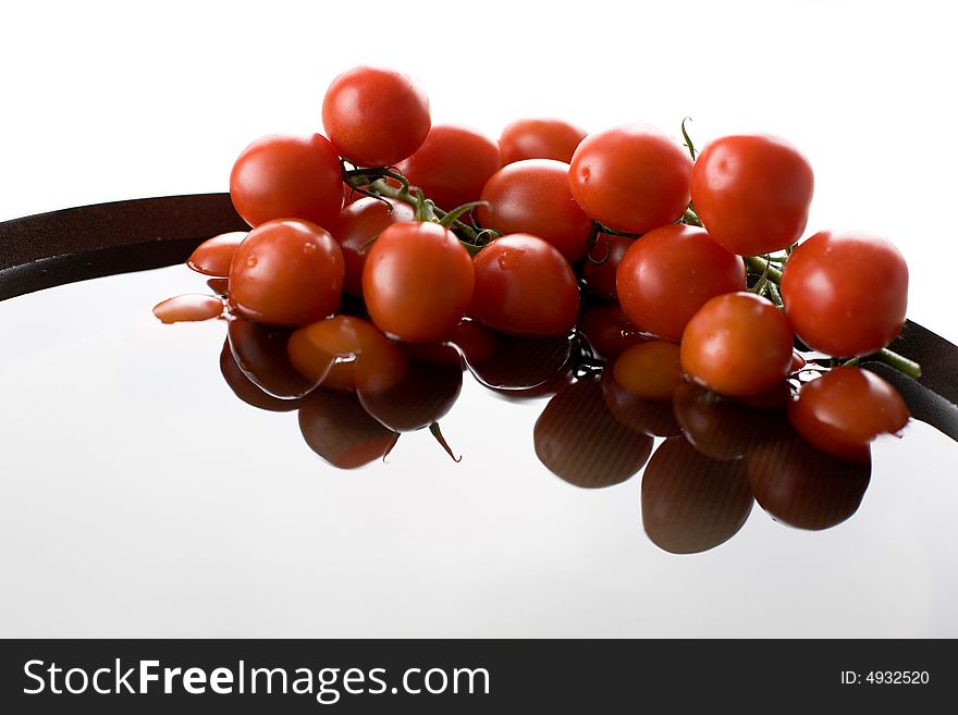 Tomato-cherry in the bowl full of fresh water. Tomato-cherry in the bowl full of fresh water