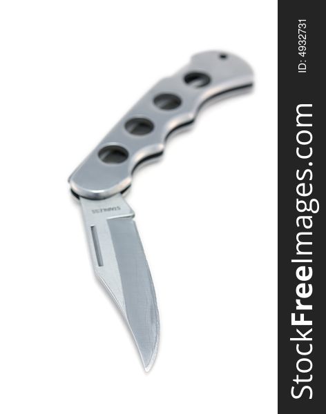 Full metal knife isolated on white, shallow depth field.