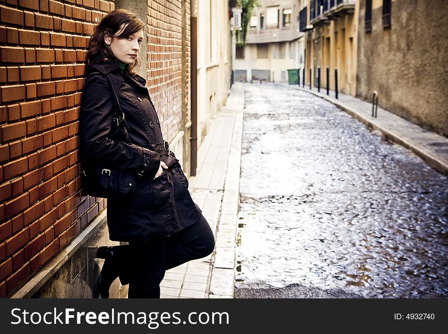 Woman on wall in urban background.