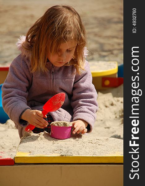 Girl playing with sand