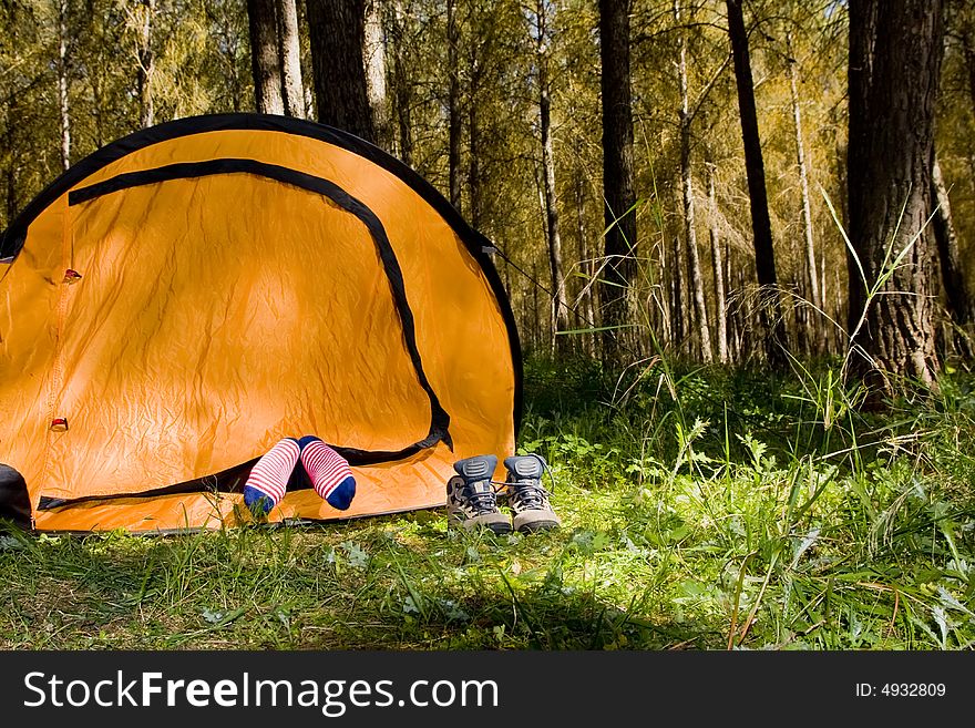 Shoes off mountaineer sleeping inside tent. Shoes off mountaineer sleeping inside tent