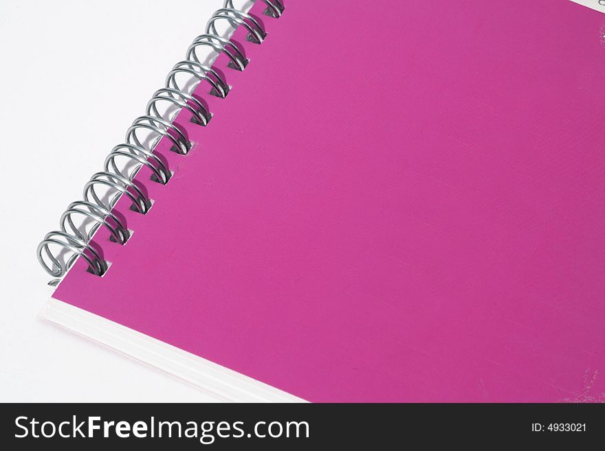 Pink notebook on a white background
