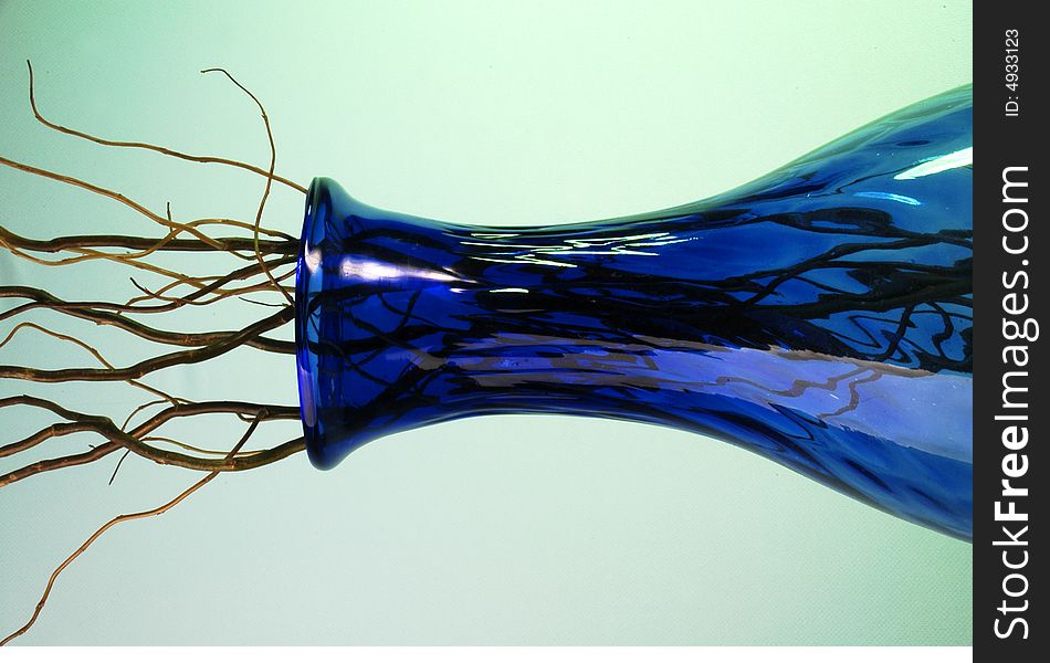 Blue glass vase with a lot of wood branches. Blue glass vase with a lot of wood branches