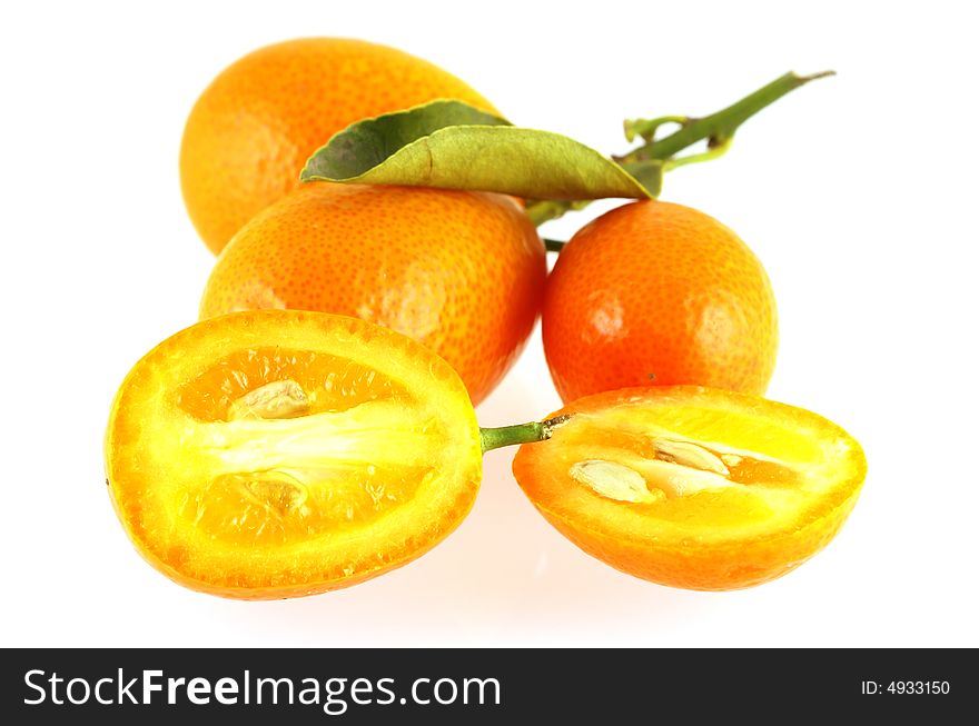 Close up of few kumquats over white