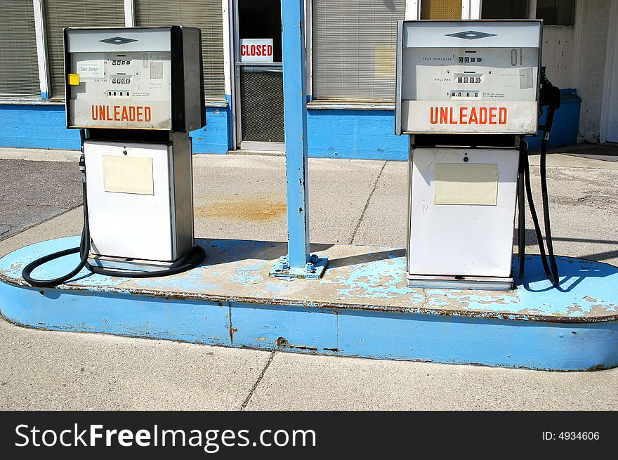 Gas pumps with unleaded sign and closed sign in the gas station window