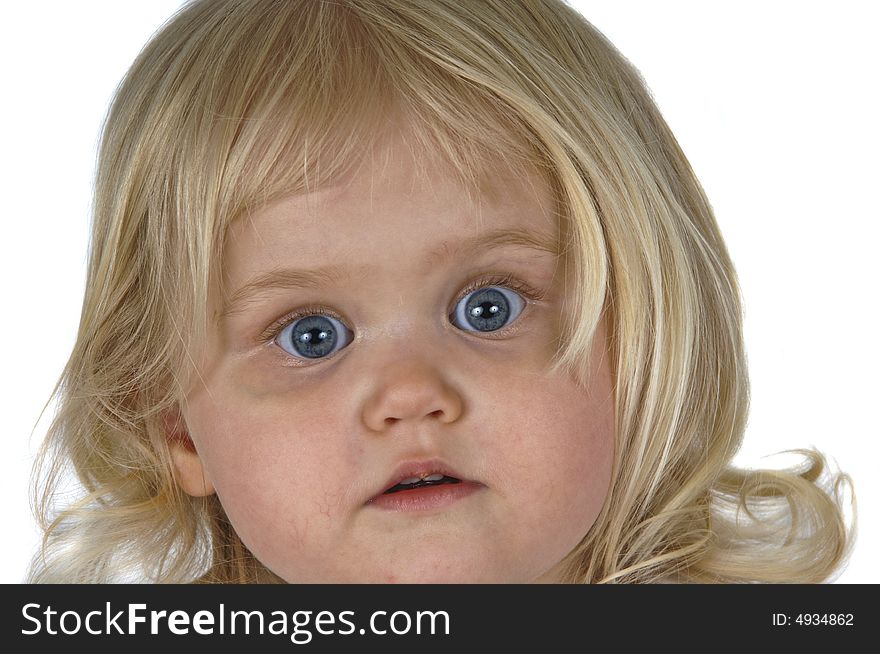 Blond baby girl with surprised looked on her face. Blond baby girl with surprised looked on her face.