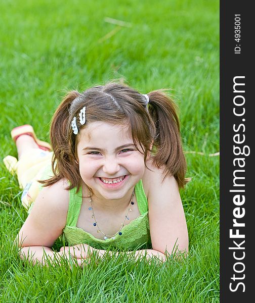 Cute Little Girl Laying in the Grass