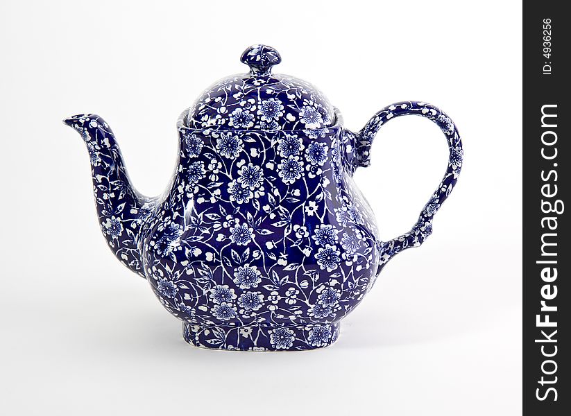 Ornate blue china teapot isolated on white. Ornate blue china teapot isolated on white