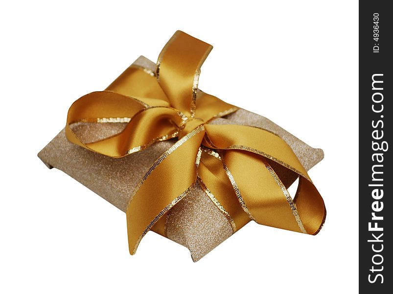 Gold and yellow ribbon around gold textured wrapping paper. Gold and yellow ribbon around gold textured wrapping paper.