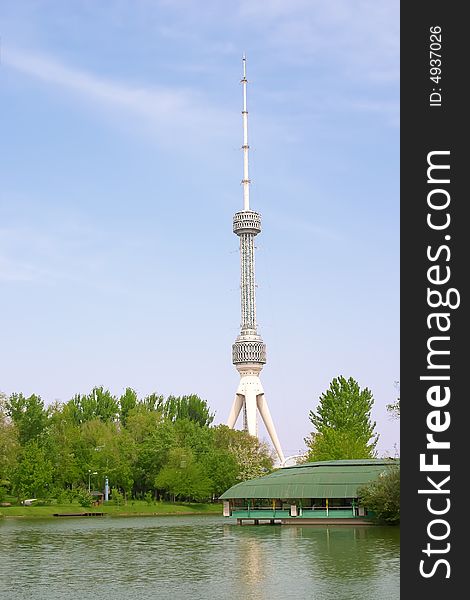 Large tv aerial near river over blue sky