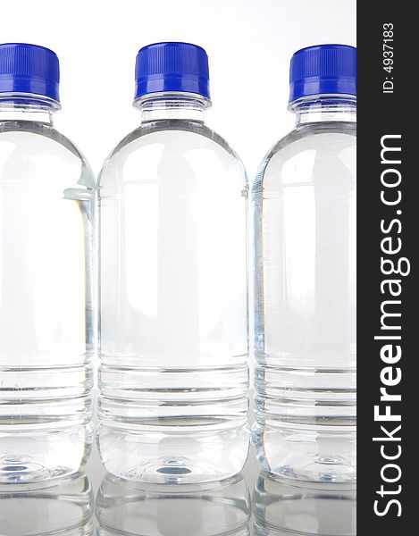 Bottled water isolated against a green background