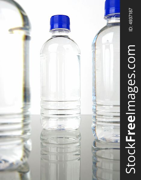 Bottled water isolated against a green background