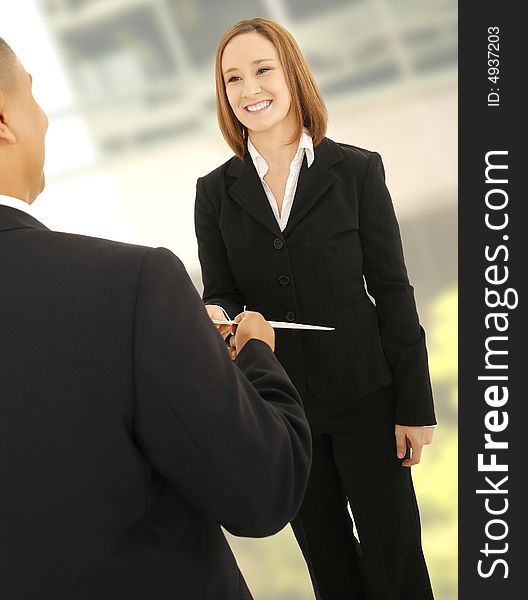 Business Man Giving Folder To Teammate