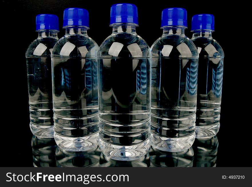 Bottled water isolated against a black background