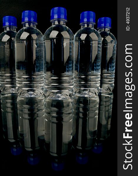 Bottled water isolated against a black background