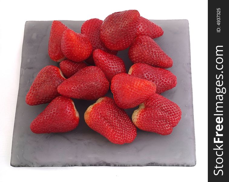 Red, fresh and tasty strawberries on the plate and white background. Red, fresh and tasty strawberries on the plate and white background