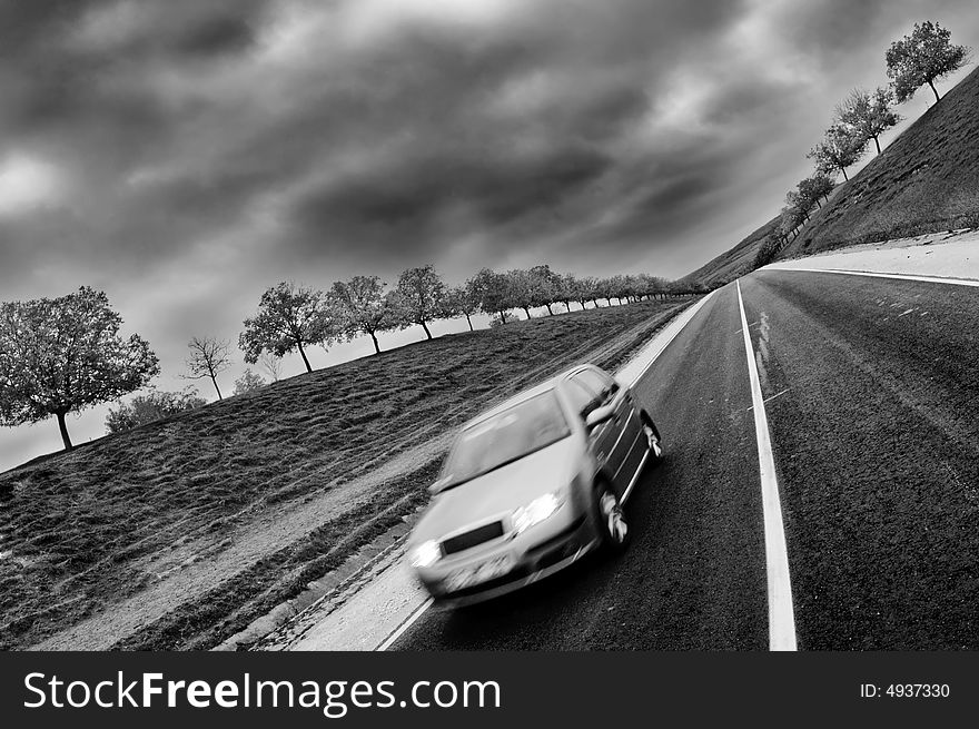 Driving car on a country road, grayscale. Driving car on a country road, grayscale