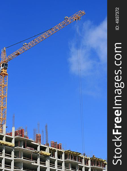 A under construction house on a background of the blue sky