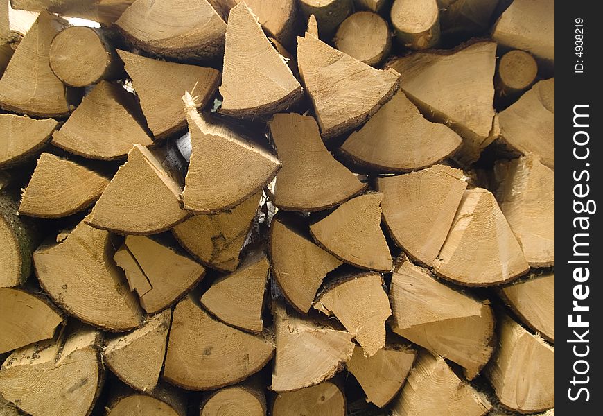 Stacked timber logs fuel for fire. Wooden background