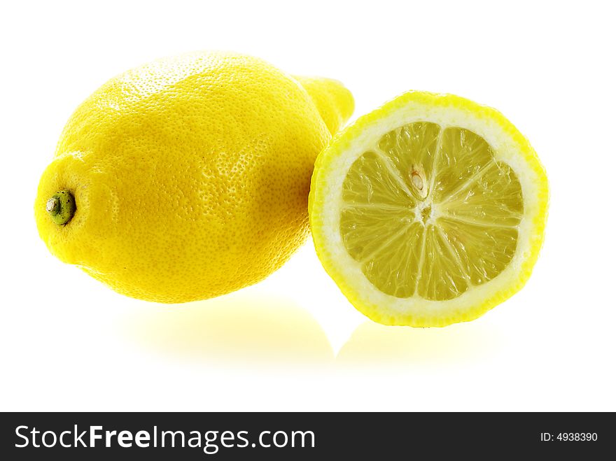 Fresh ripe lemon with a slice over white background