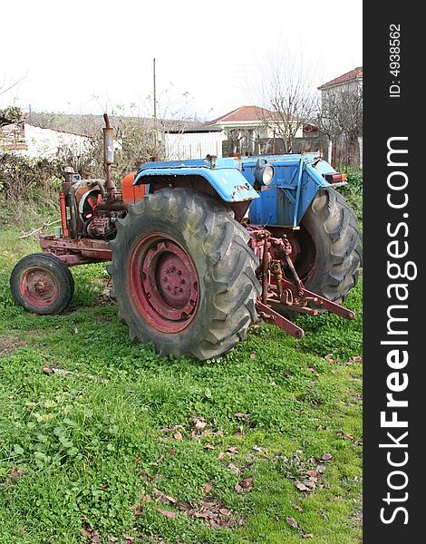 Old trakter in a green farm in Greece