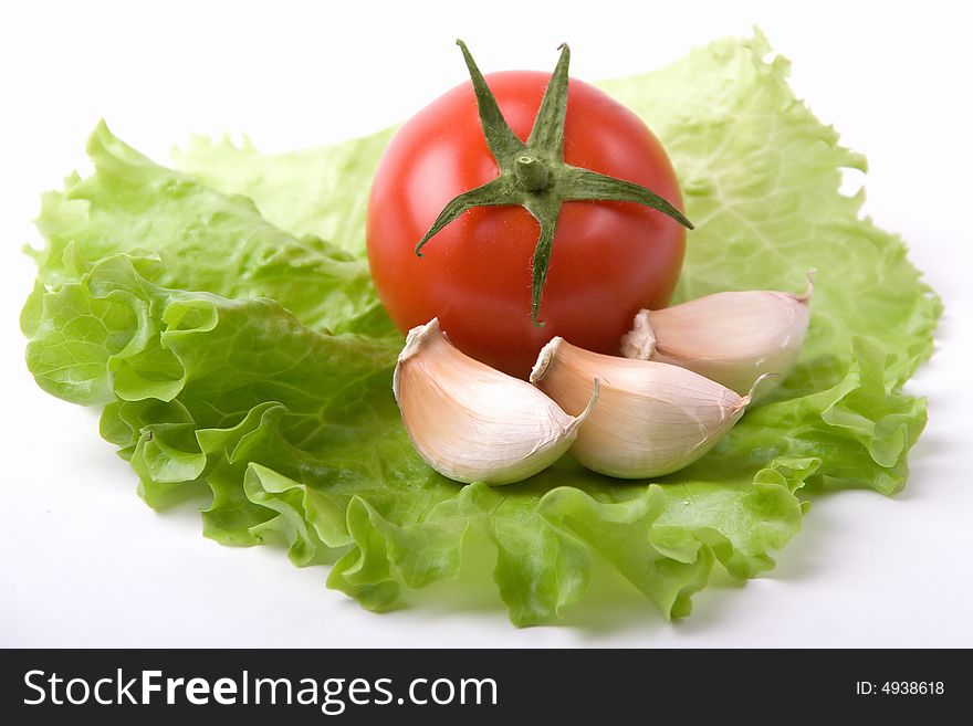 A photo of a fresh tomato with garlic on salad. A photo of a fresh tomato with garlic on salad
