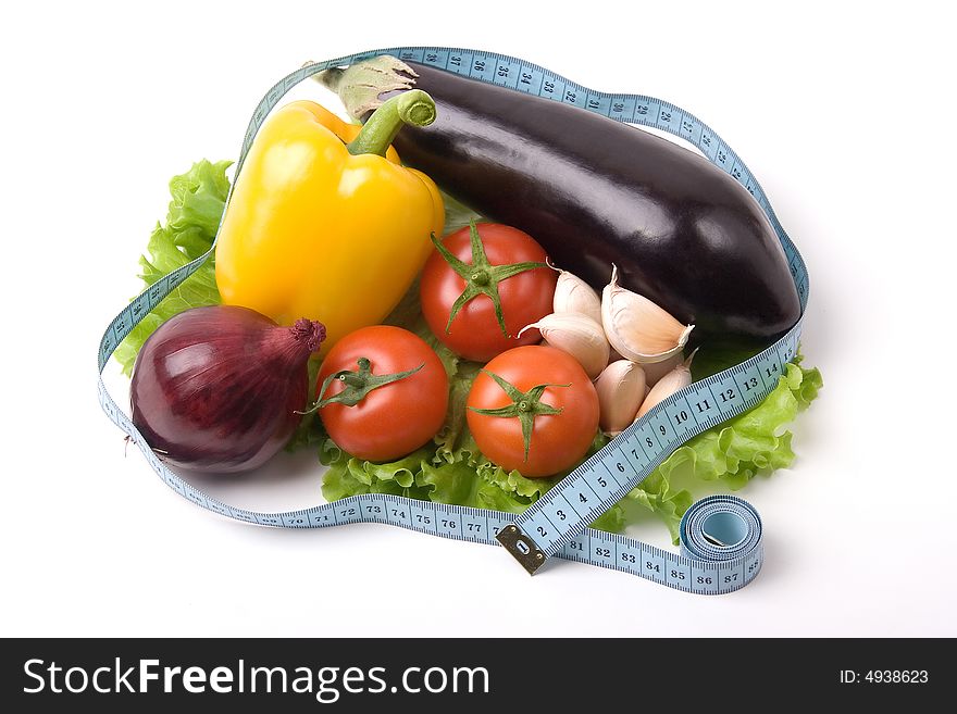 A photo of fresh vegetables binded with measure tape. A photo of fresh vegetables binded with measure tape