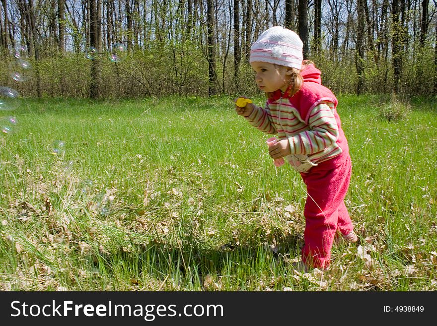 Nice child blowing soap bubbles