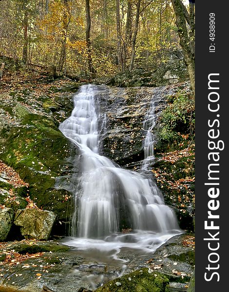 Small waterfall viewed in mid autumn along hiking trail. Small waterfall viewed in mid autumn along hiking trail.