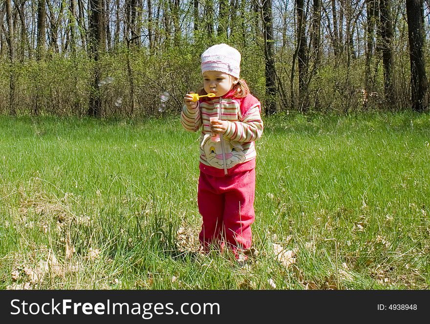 Little child blowing soap bubbles. Little child blowing soap bubbles