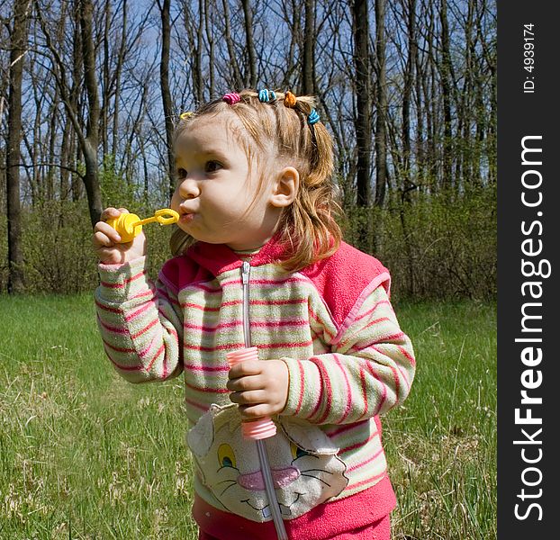 Little child blowing soap bubbles. Little child blowing soap bubbles