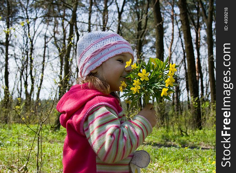 Little girl with bunch of flowers