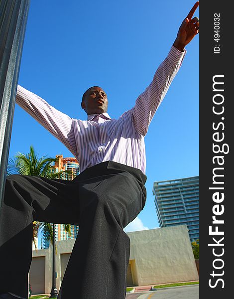 Man hanging from a light pole