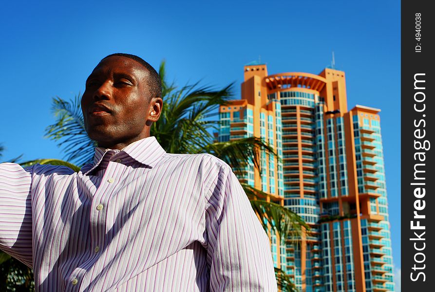 Man appearing to be tall with a building behind him. Man appearing to be tall with a building behind him.