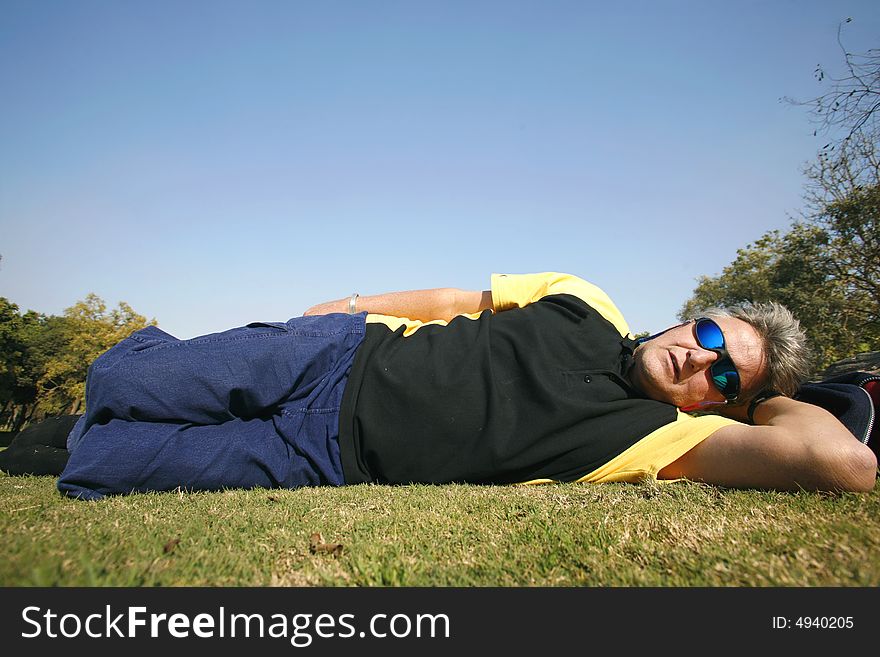 Man in park relaxing on grass