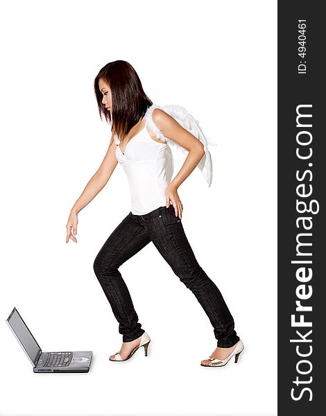 Woman with angel wings pointing while looking on the laptop. Woman with angel wings pointing while looking on the laptop